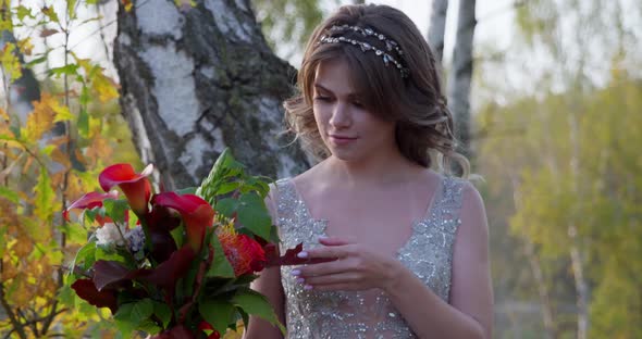 A Young Woman Dressed in a Gray Wedding Dress Celebrates Her Wedding. She Has Flowers in Her Hand