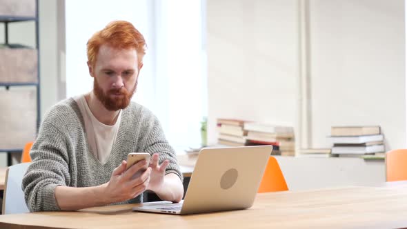 Man Using Smartphone, Browsing online at Work