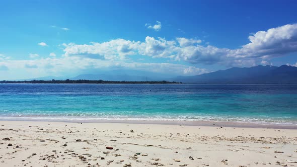 Luxury fly over abstract view of a sunshine white sandy paradise beach and blue sea background in be