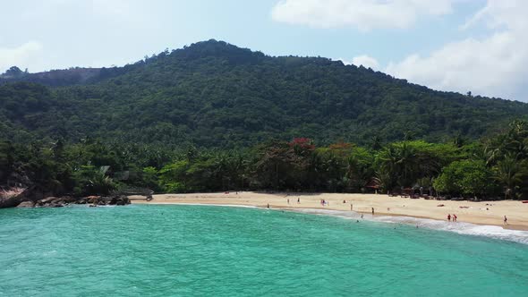 foamy waves washing the white sand shore of Koh Phangan island, Thailand