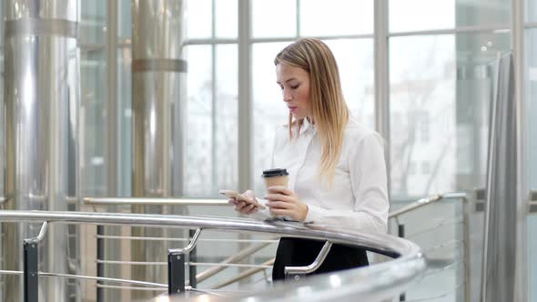 Caucasian clerk scrolling electronic book on the phone indoor