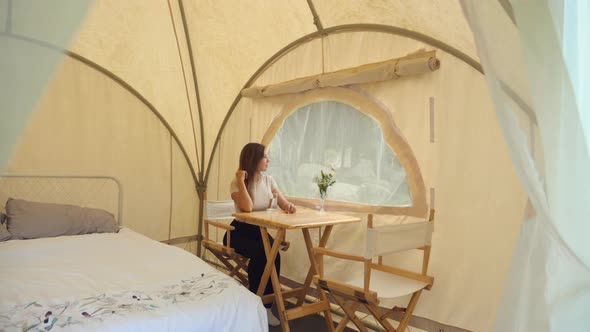 Woman Tourist Inside Camp Tent Sitting Near Window and Enjoy Nature