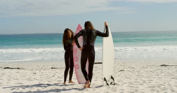 Couple with surfboard interacting each other 4k