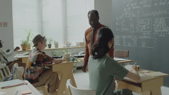 African American Professor Walking in Classroom during Test