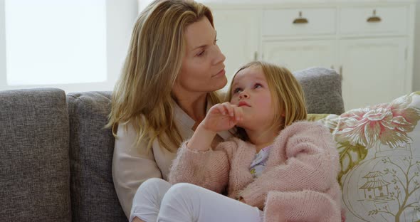 Mother interacting with her daughter in living room 4k