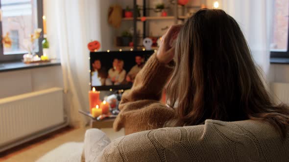 Young Woman Watching Tv at Home on Halloween