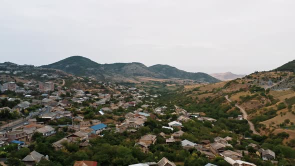 Aerial Drone Zoom in of Mountains and Houses in Armenia