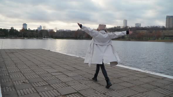 Girl Walks Along the Stunning Embankment