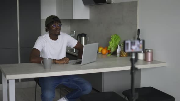 Black Male Blogger Talking to the Subcribers Recording Video on Camera Streaming