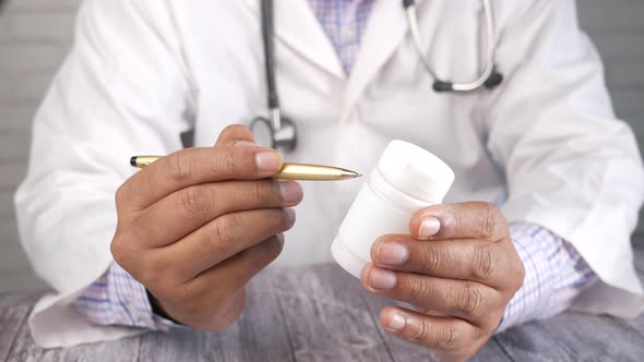 Doctor Hand Holding Pill Container with Copy Space