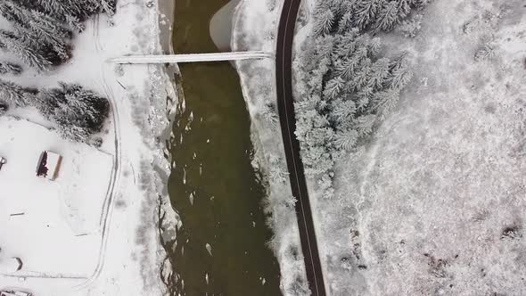 Drone Winter Over River and Road with Forest
