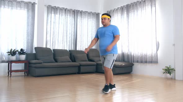 Overweight Man Doing Forward Lunge Exercises At Home