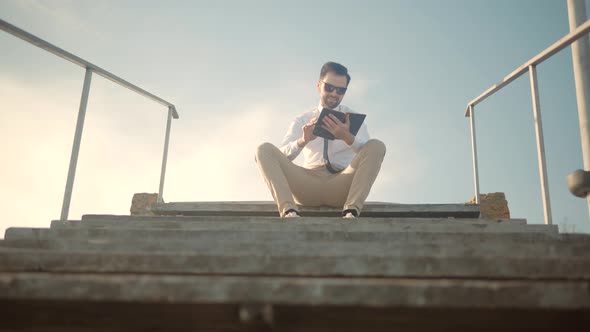 Businessman Relaxing And Enjoying Near River Resting Holding Book. Businessman Take Break Relax.