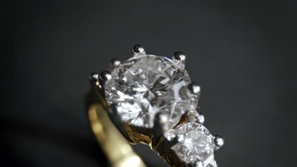 Extreme detailed of diamond ring close up shot while rotating on dark background