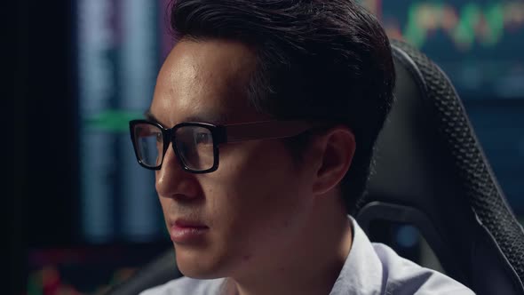 Close Up Face's Asian Male Stock Market Broker Working On Computer