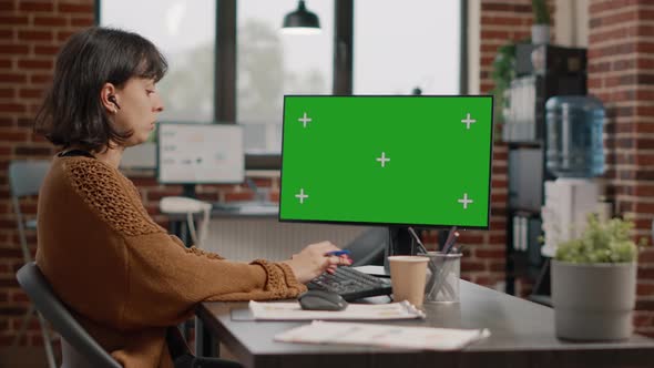 Woman Working with Horizontal Green Screen on Monitor