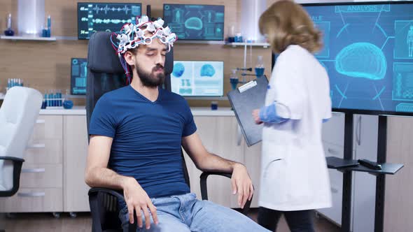 Patient with Brainwaves Scanning Headset Closing His Eyes