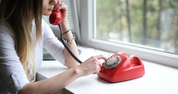 Beautiful Brunette Woman Using Old Retro Telephone at Home