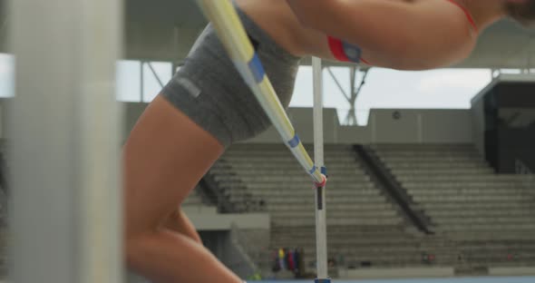 Close up view of caucasian athlete doing high jump