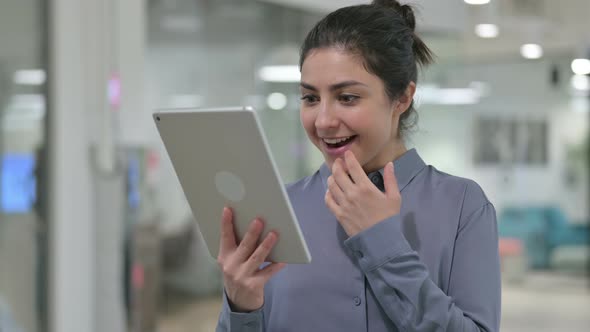 Portrait of Successful Indian Woman Celebrating on Tablet