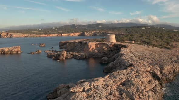 Dramatic view of pirate tower in Ibiza. Panning around lookout tower showing landscape, cliffs and o