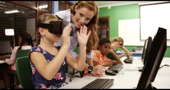 Schoolgirl using virtual reality glasses in classroom