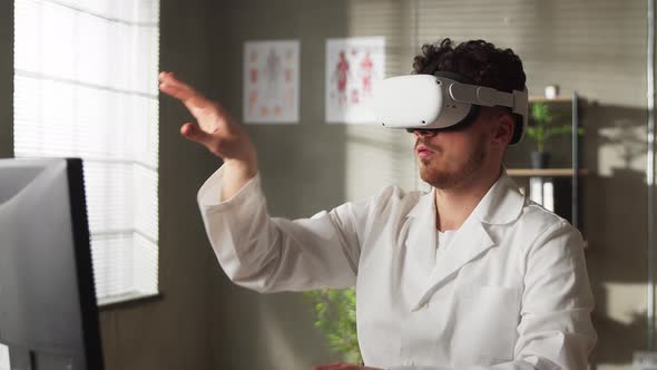 Young Male Doctor Conducting Experimental Medical Procedure Wearing Virtual Reality Headset in