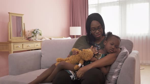 Portrait of smiling business black African american woman, a mom with her daughter lull the child t