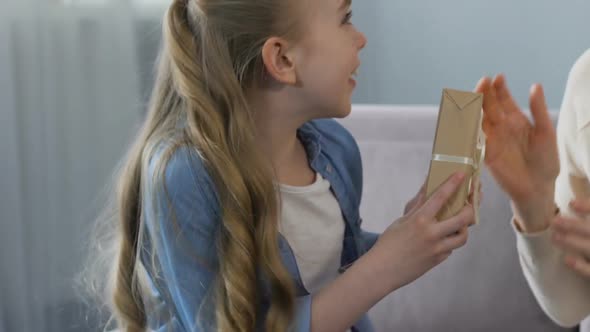 Little Girl Making Surprise to Her Granny, Anniversary Celebration, Tender Gift