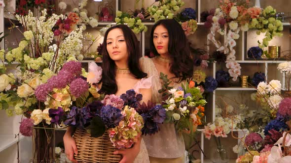 Florists. Asian Women Happy Working in Flower Store