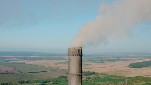 Aerial Drone View of High Chimney Pipes with Grey Smoke From Coal Power Plant
