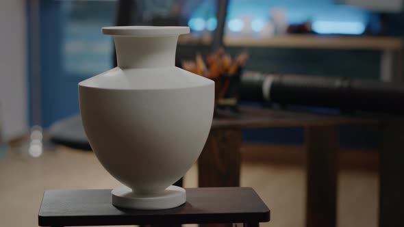 Close Up of White Vase on Table in Artwork Studio at Home