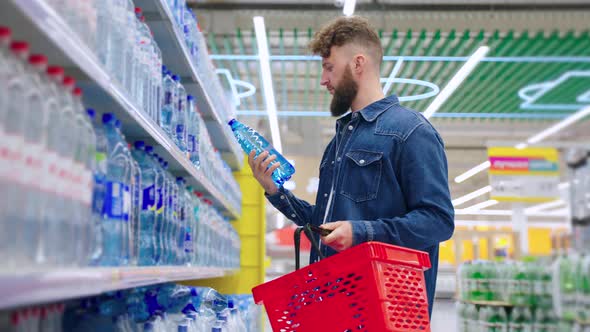 Man Buying Mineral Water in the Shop