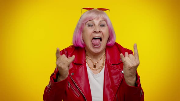 Overjoyed Delighted Crazy Elderly Woman Showing Rock n Roll Gesture By Hands Cool Sign Dancing