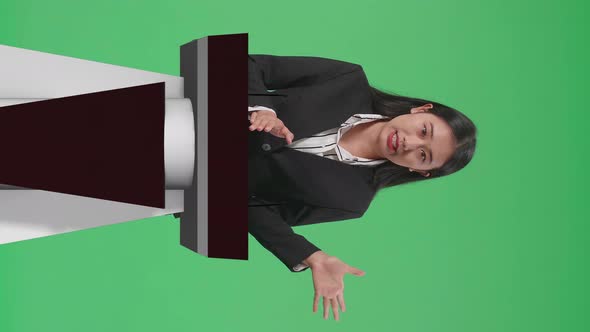 Asian Woman Of Organization Representative Pointing On Something While Speaking On Green Screen