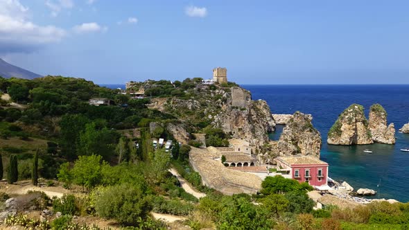 Panning slow-motion of Stacks or Faraglioni of Scopello and surrounding landscape in Sicily. Italy