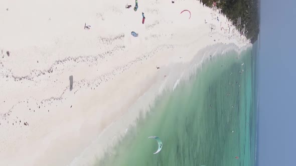 Zanzibar Tanzania  Vertical Video Kitesurfing Near the Shore of Ocean Slow Motion