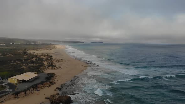 Ponta da Calheta beach at Porto Santo island on stormy day, Madeira in Portugal. Aaerial forward