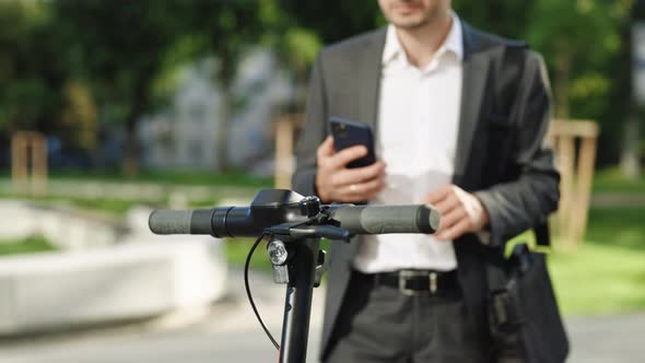 Unrecognizable Tourist Businessman Take Electric Kick Scooter or Bike Bicycle in Sharing Parking Lot