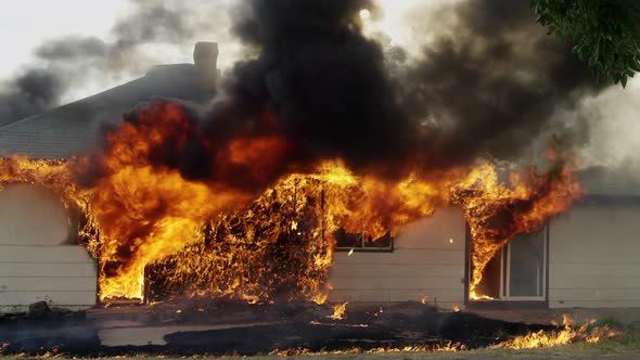 House on fire burning in slow motion