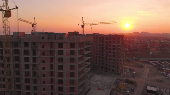 Construction Site in the Middle of the City and Private Houses at Sunset