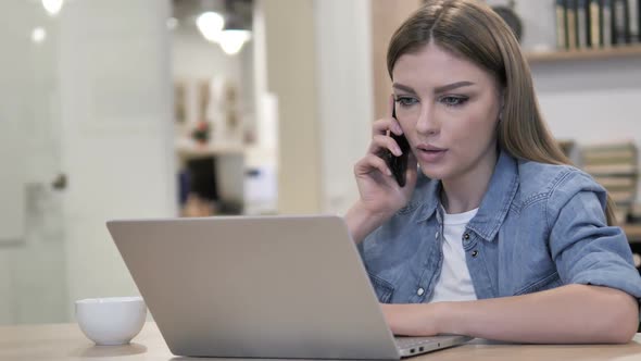 Young Girl Talking on Phone at Work