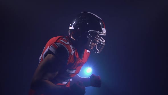 Portrait of Determined Professional American Football Player in Helmet in Bright Stadium