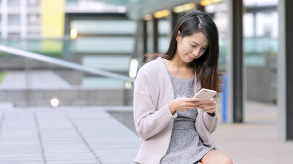 Woman using cellphone for online