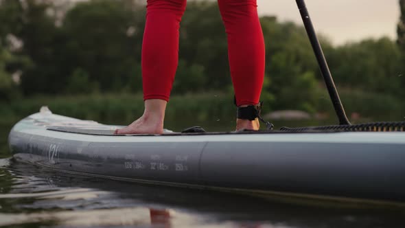 Legs of Female SUP Boarder