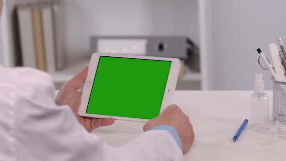 Male Doctor Consults Patient Using Tablet with Green Screen Chroma Key