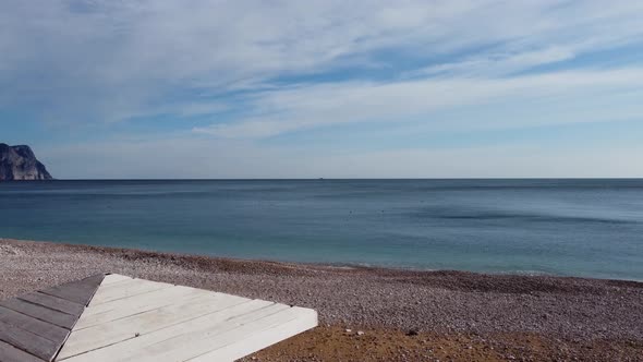 Aerial View From Above on Azure Sea and Pink Pebbles Beach