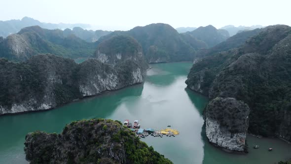 Aerial: flying over Ha Long Bay rock pinnacles, famous tourism destination in Vietnam