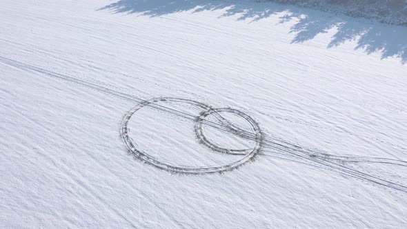 Snow trails from vehicle tires 4K drone footage