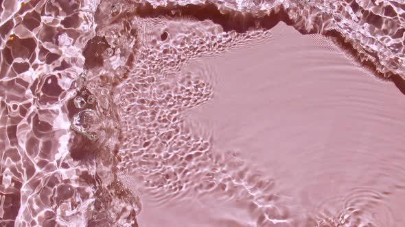 Pure Pink Water with Reflections Sunlight in Slow Motion